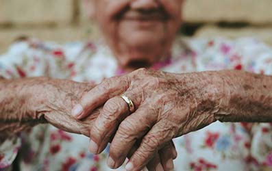 an Elderly Woman Holding Hands