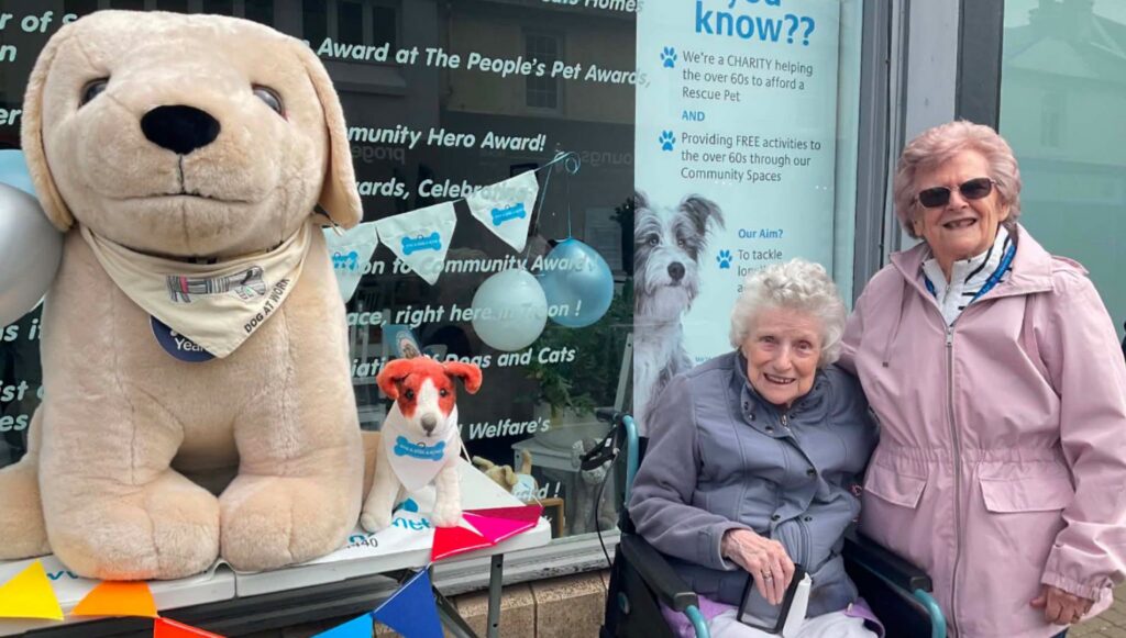 older ladies by a charity table for service dogs