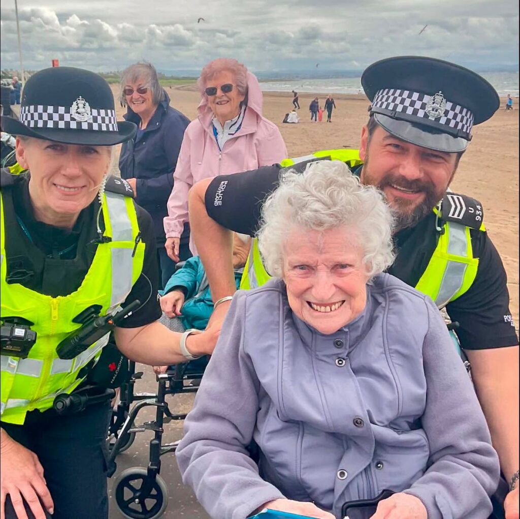 police officers posing for a selfie with older ladies
