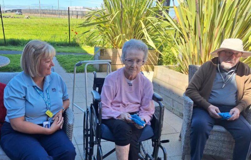 residents and carer sat outside